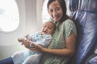 plane infant mom lap window airplane