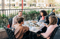 Enjoying a family meal on the spacious patio at Olive & Ivy on the Scottsdale Waterfront. Credit: Delight in the Desert for Experience Scottsdale.