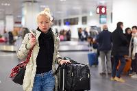 woman arrivals bag luggage waiting airport
